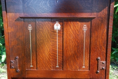 Close-up of pewter, copper & curly maple inlaid panels in the drop front door.